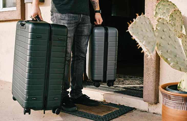 Man Holding Suitcases With What To Bring To Rehab At The Hope house