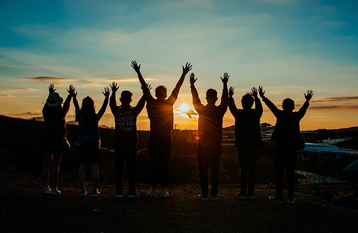 people standing on mountain with hands raised cheering about beating cocaine addiction after finishing cocaine rehab.jpg