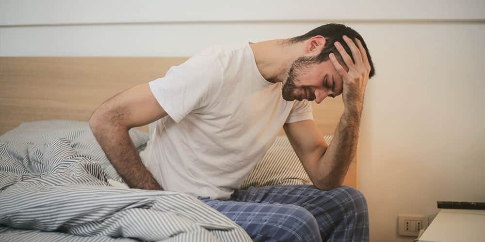 a man feeling a lot of pain from his illness