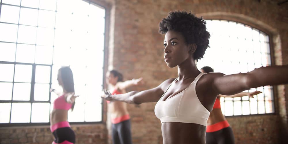 a woman participating in an exercise session along with other people