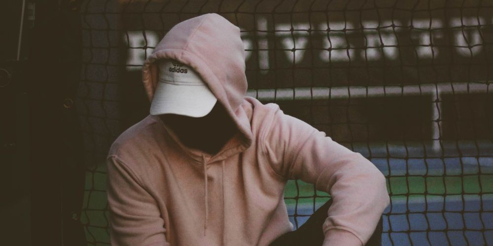 photo of a man with a hoodie going through withdrawal symptoms
