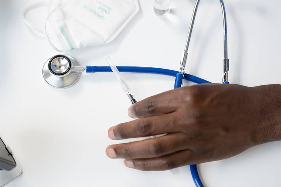 photo of doctors hand and medical materials