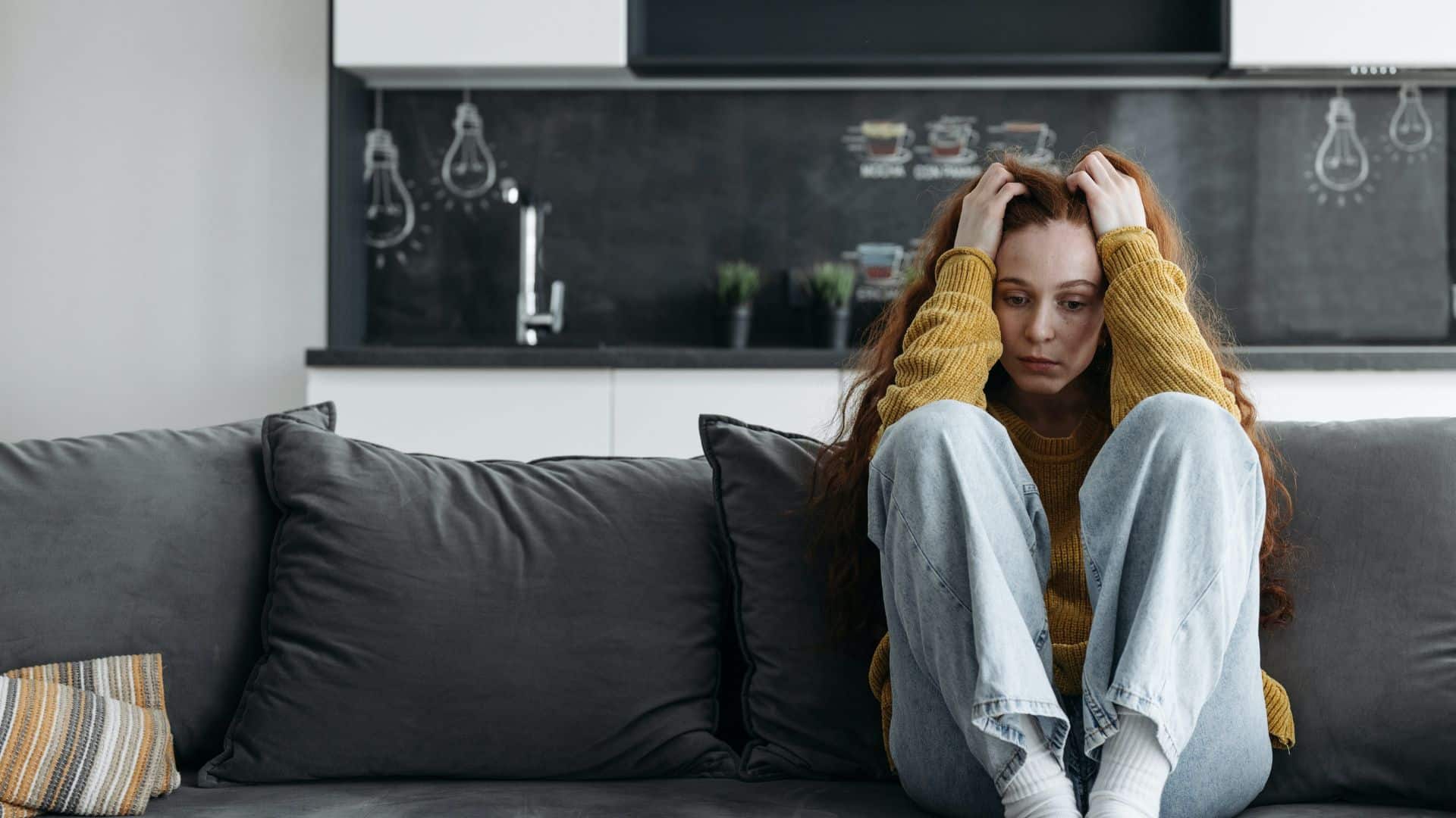 photo of a woman sitting on a couch in isolation