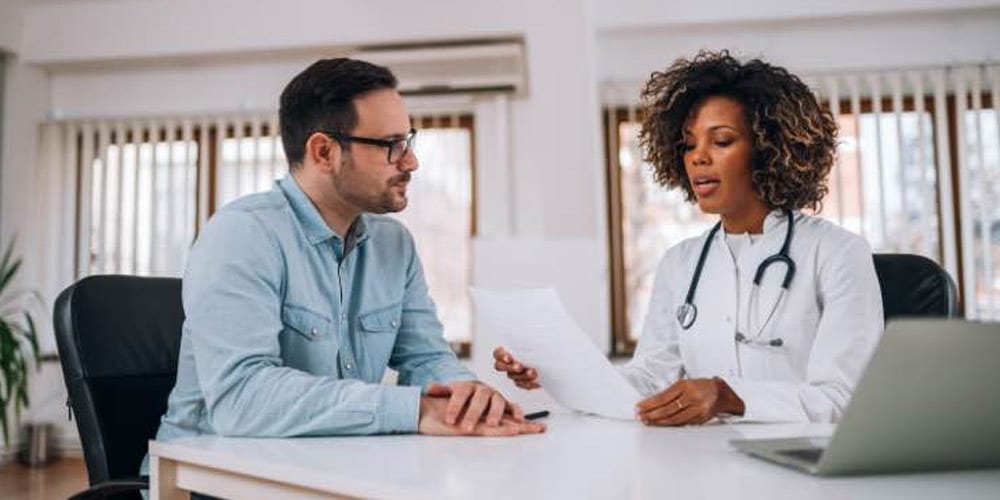 a doctor going over a clients treatment plan