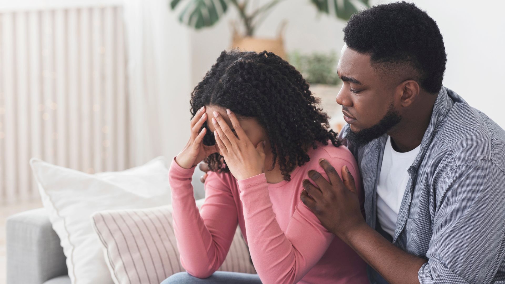 Caring black boyfriend comforting his upset crying girlfriend