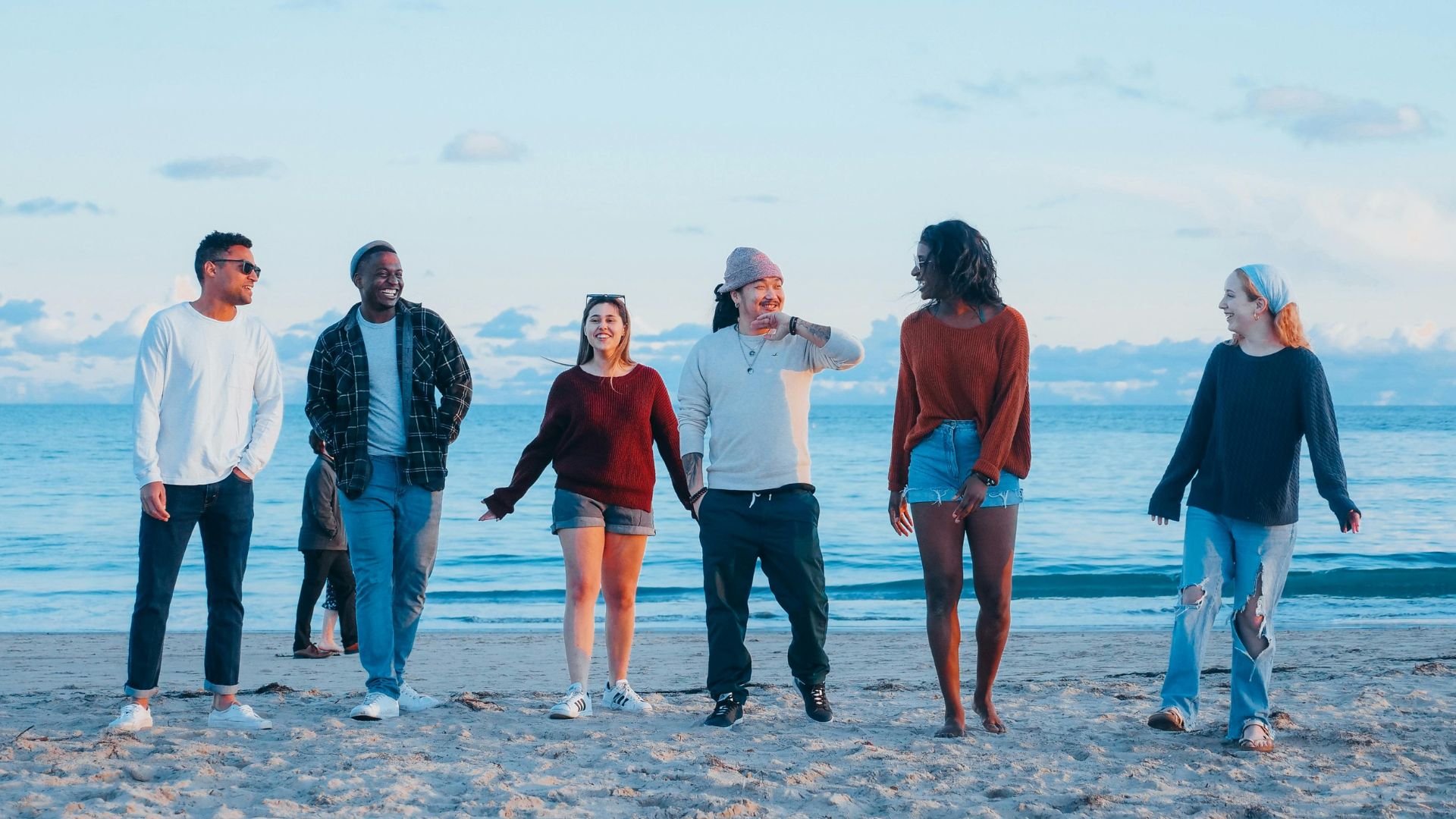 Group of Friends Walking on Beach Shore