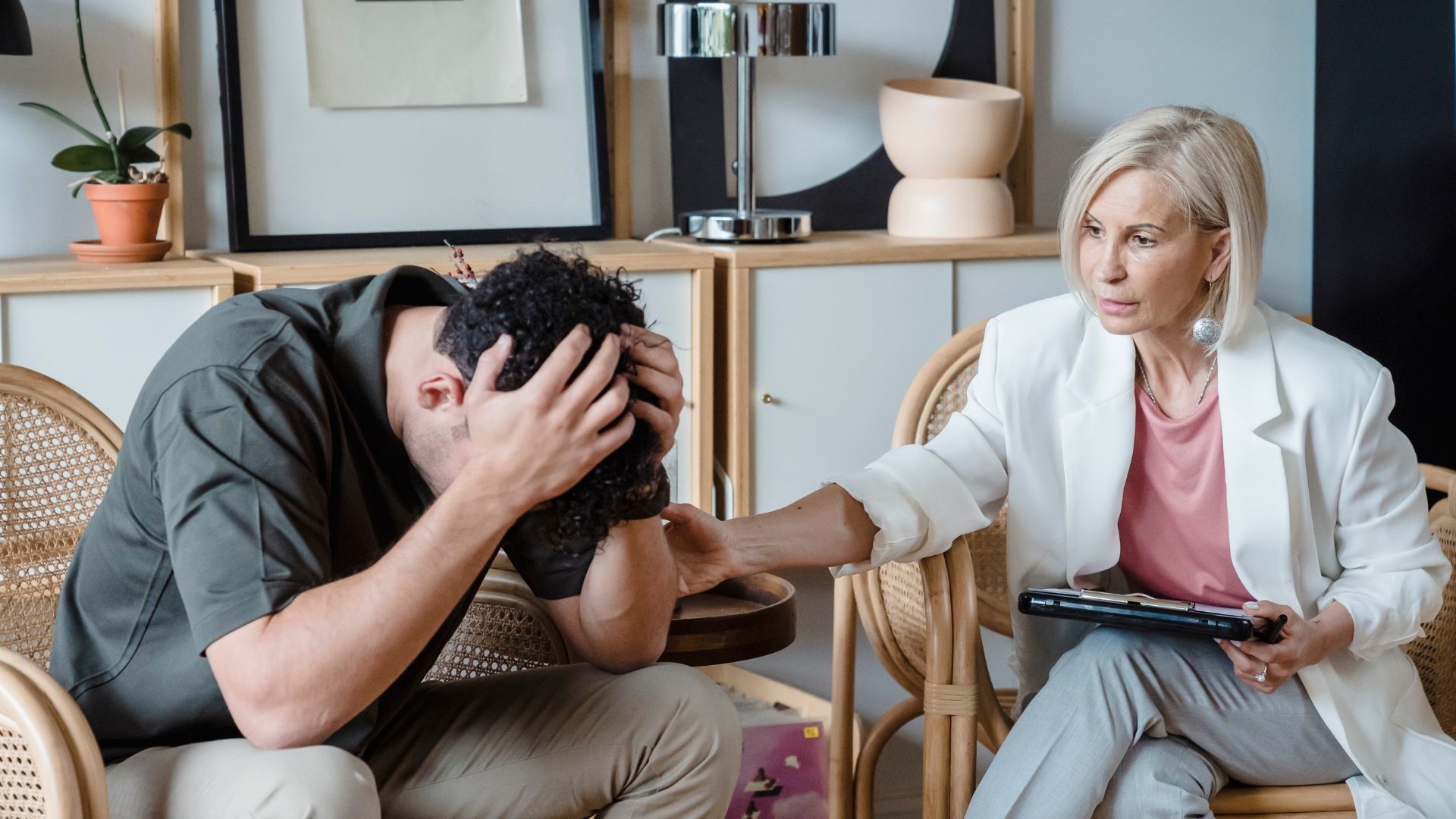 A supportive therapist provides comfort during a counseling session