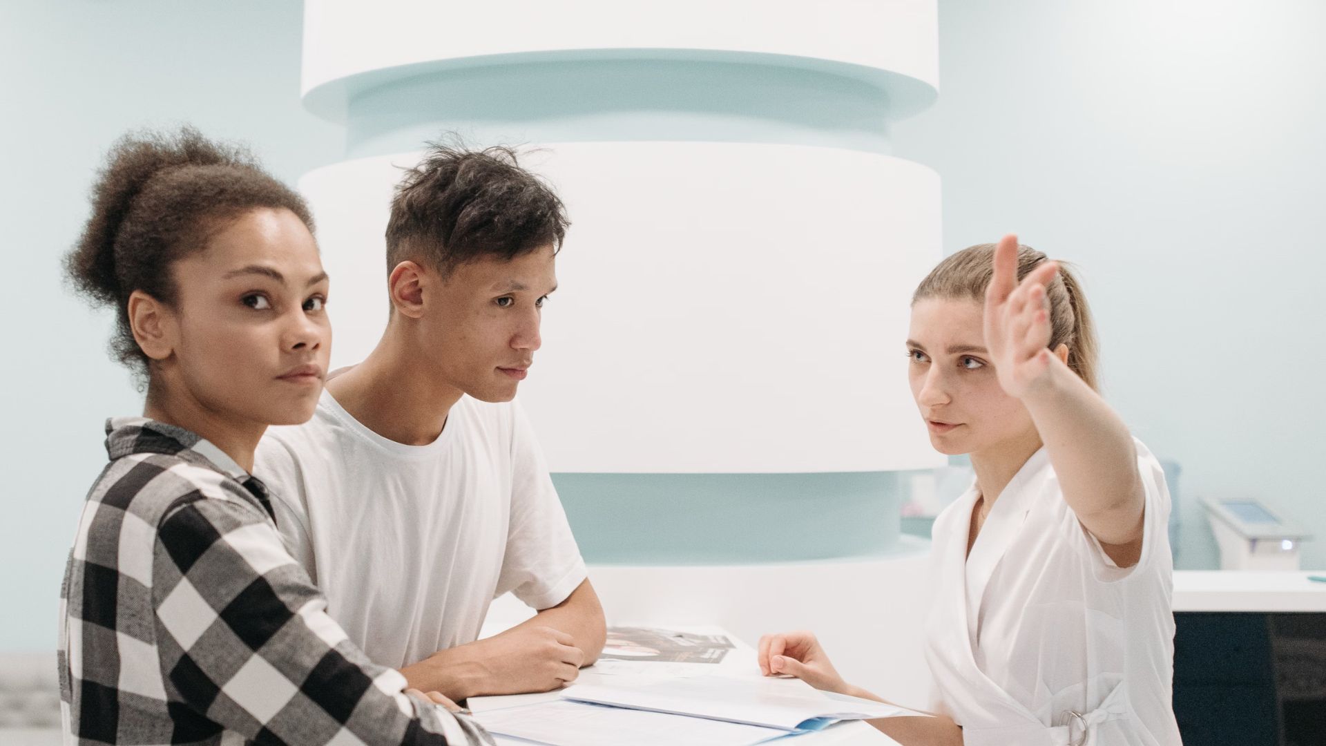 Two patients at hospital reception desk