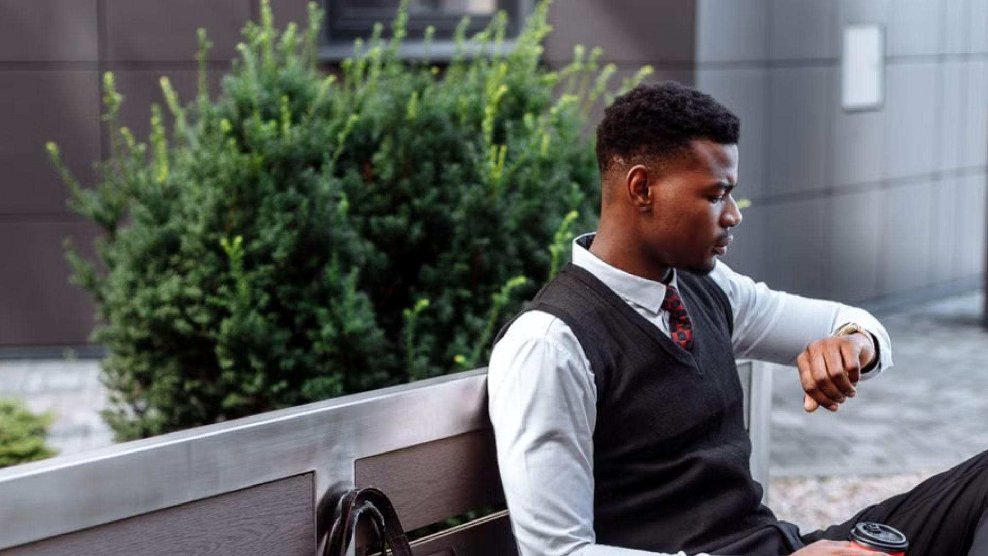 Young professional sitting on a bench